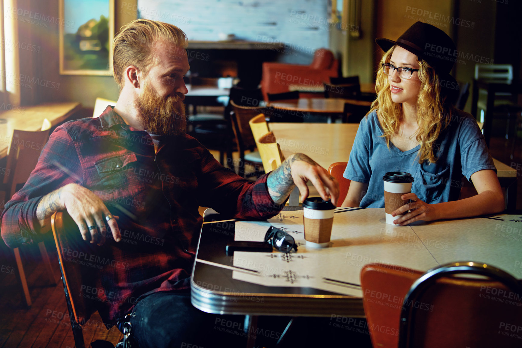 Buy stock photo Cropped shot of a hipster couple in a coffee shop