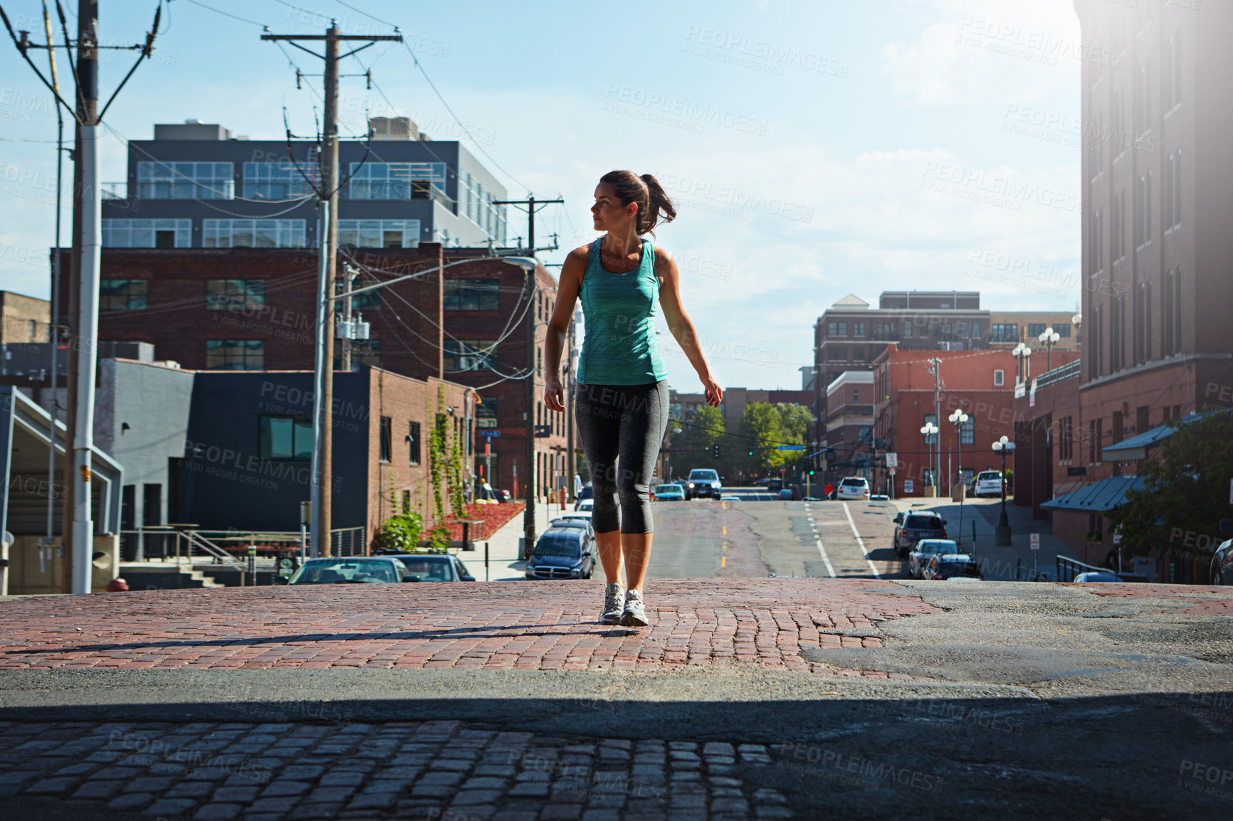 Buy stock photo Shot of an attractive young female runner exercising outdoors