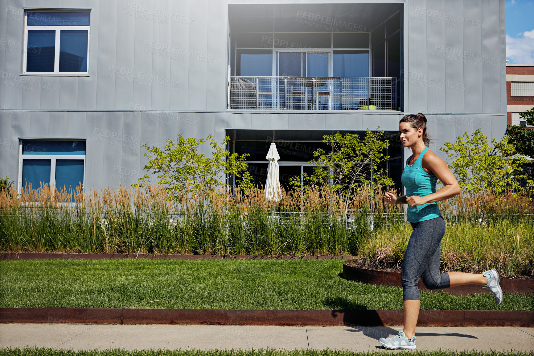 Buy stock photo Shot of an attractive young female runner exercising outdoors