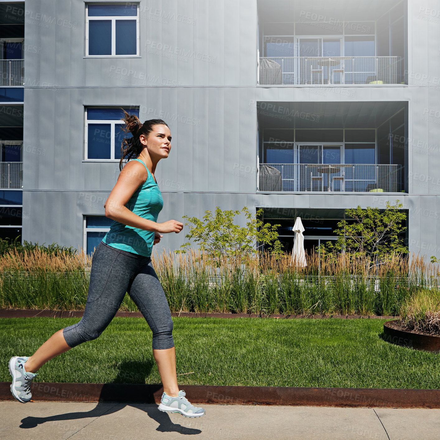 Buy stock photo Shot of an attractive young female runner exercising outdoors