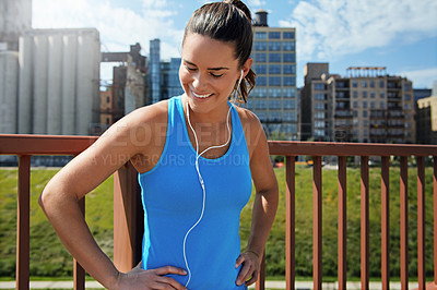 Buy stock photo Shot of an attractive young female runner exercising outdoors