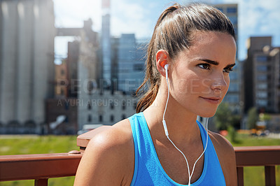 Buy stock photo Shot of an attractive young female runner exercising outdoors