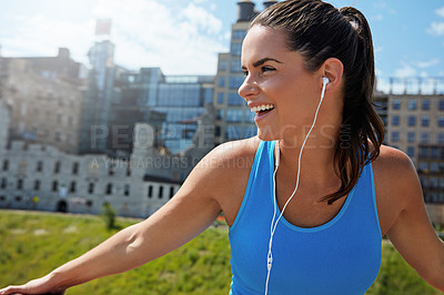 Buy stock photo Shot of an attractive young female runner exercising outdoors