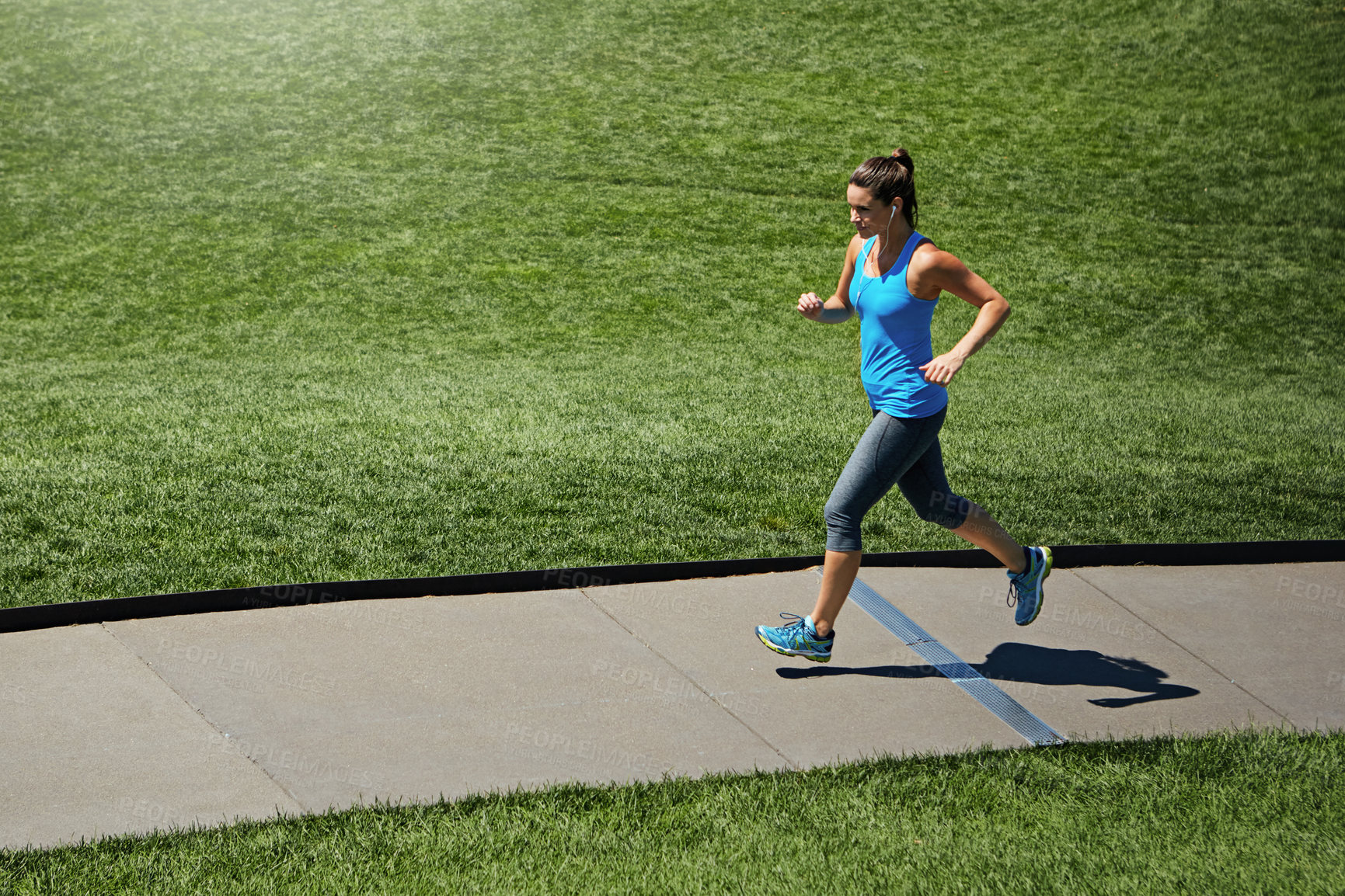 Buy stock photo Running, path and woman in park for fitness, exercise and marathon training with earphones. Sports, runner and person with music, audio and track for workout for health, wellness and podcast