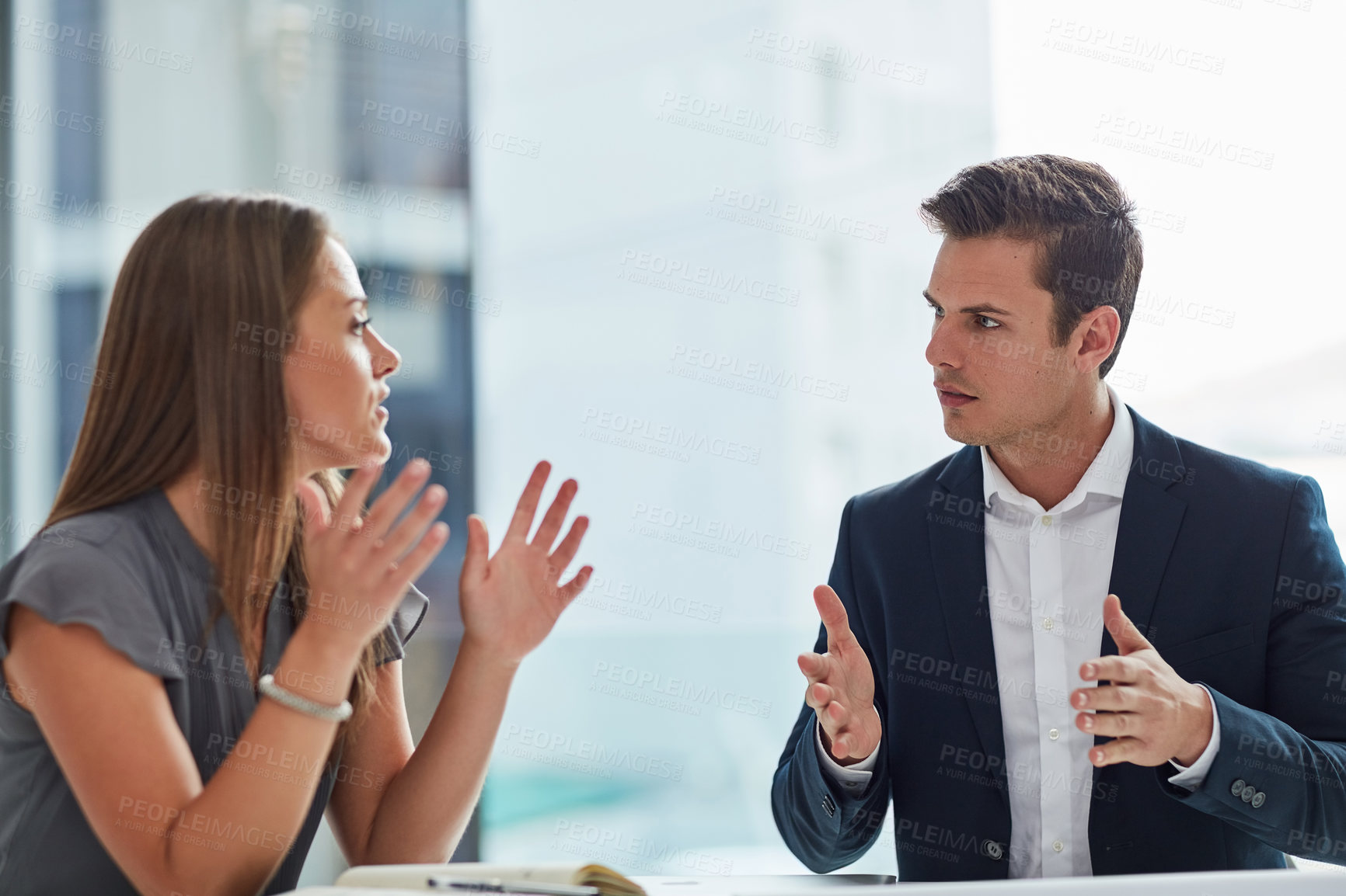 Buy stock photo Cropped shot of two businesspeople having a discussion in the office