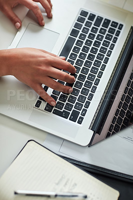 Buy stock photo Cropped shot of an unrecognizable woman working on her laptop