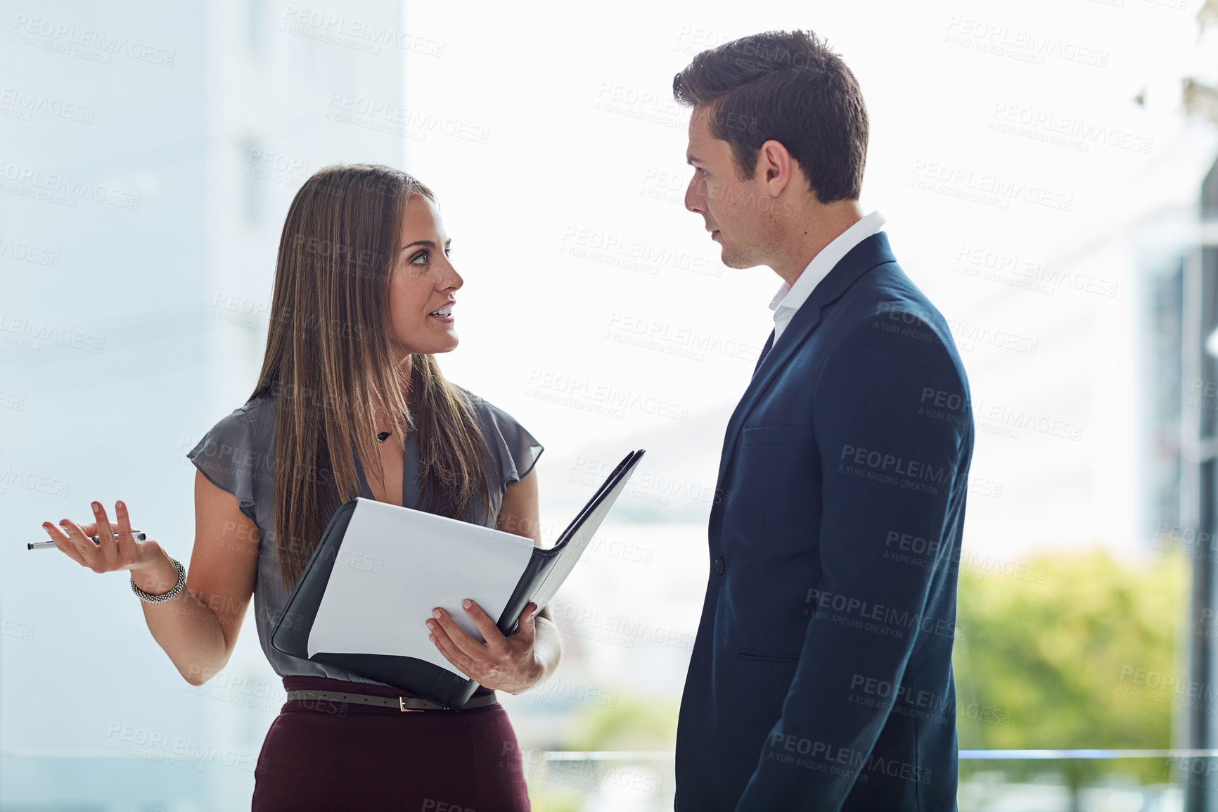 Buy stock photo Cropped shot of two businesspeople having a discussion in the office