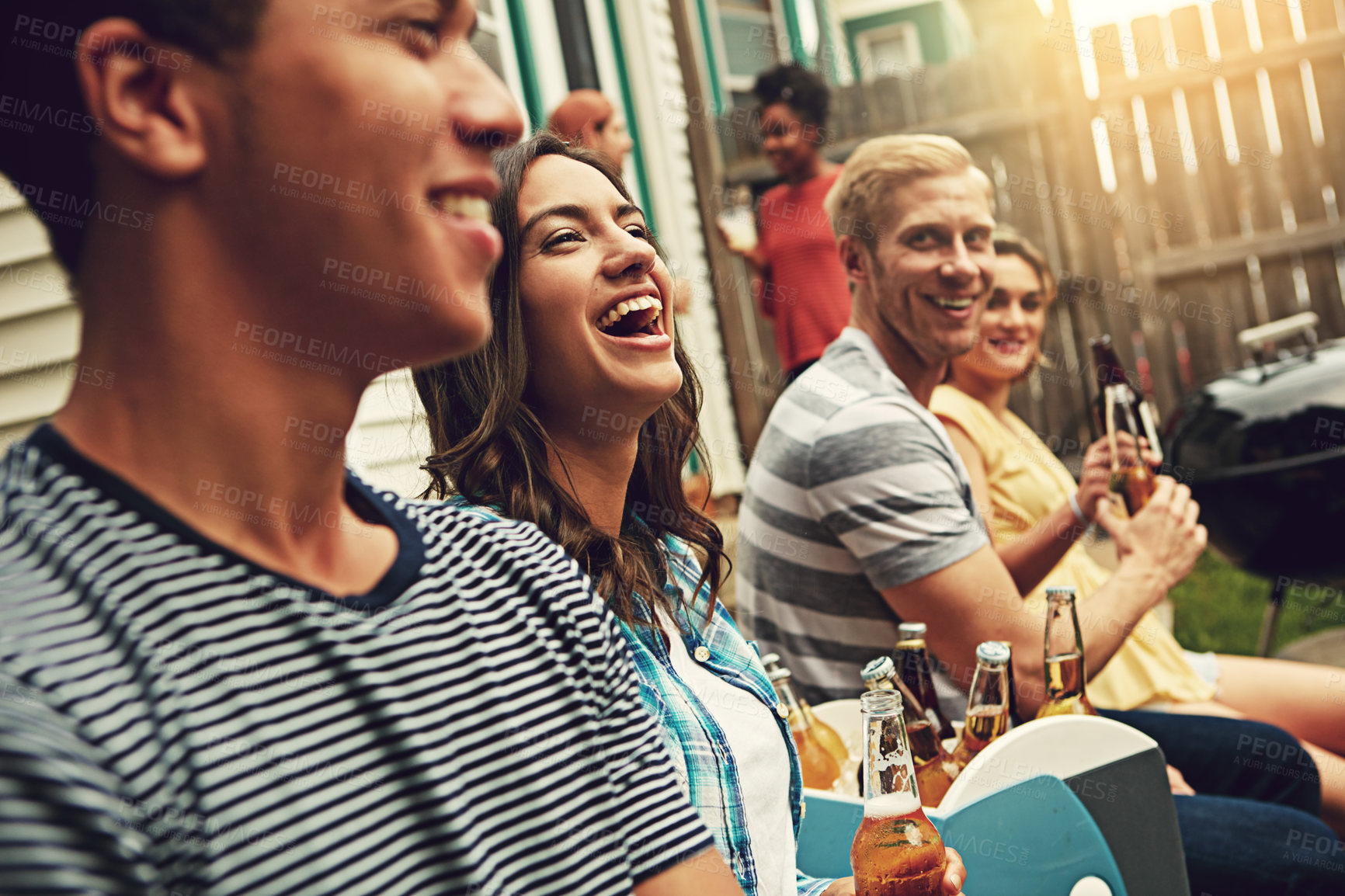 Buy stock photo Shot of a group of friends enjoying a party outdoors