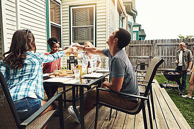 Buy stock photo Shot of a group of friends having a barbecue in the yard