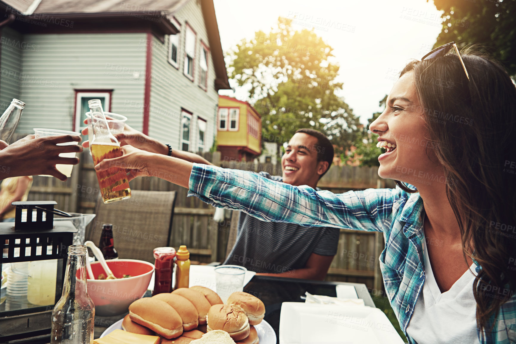 Buy stock photo Outdoor, people and friends in alcohol, cheers and celebration for reunion, party and meal in weekend. Backyard, man and woman in group, together and food to enjoy, drinks and lunch to relax for fun