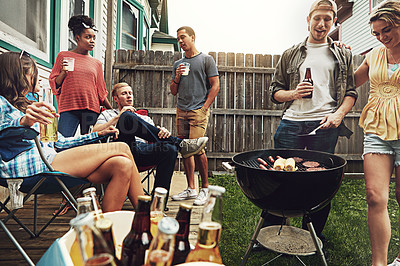 Buy stock photo Shot of a group of friends having a barbecue in the yard