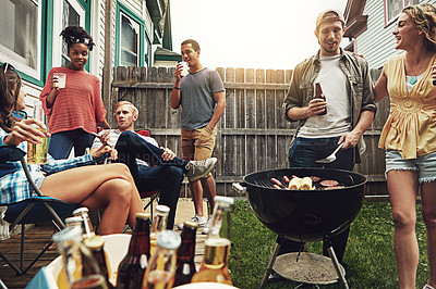 Buy stock photo Shot of a group of friends having a barbecue in the yard