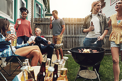 Buy stock photo Shot of a group of friends having a barbecue in the yard