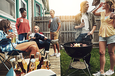 Buy stock photo Shot of a group of friends having a barbecue in the yard