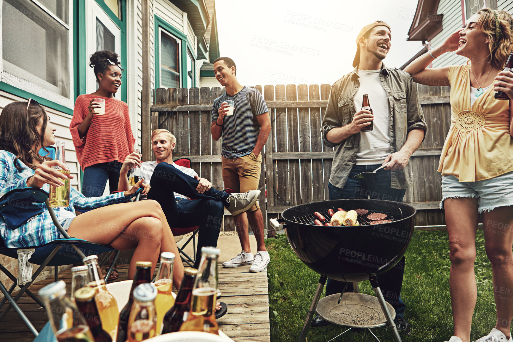 Buy stock photo Shot of a group of friends having a barbecue in the yard