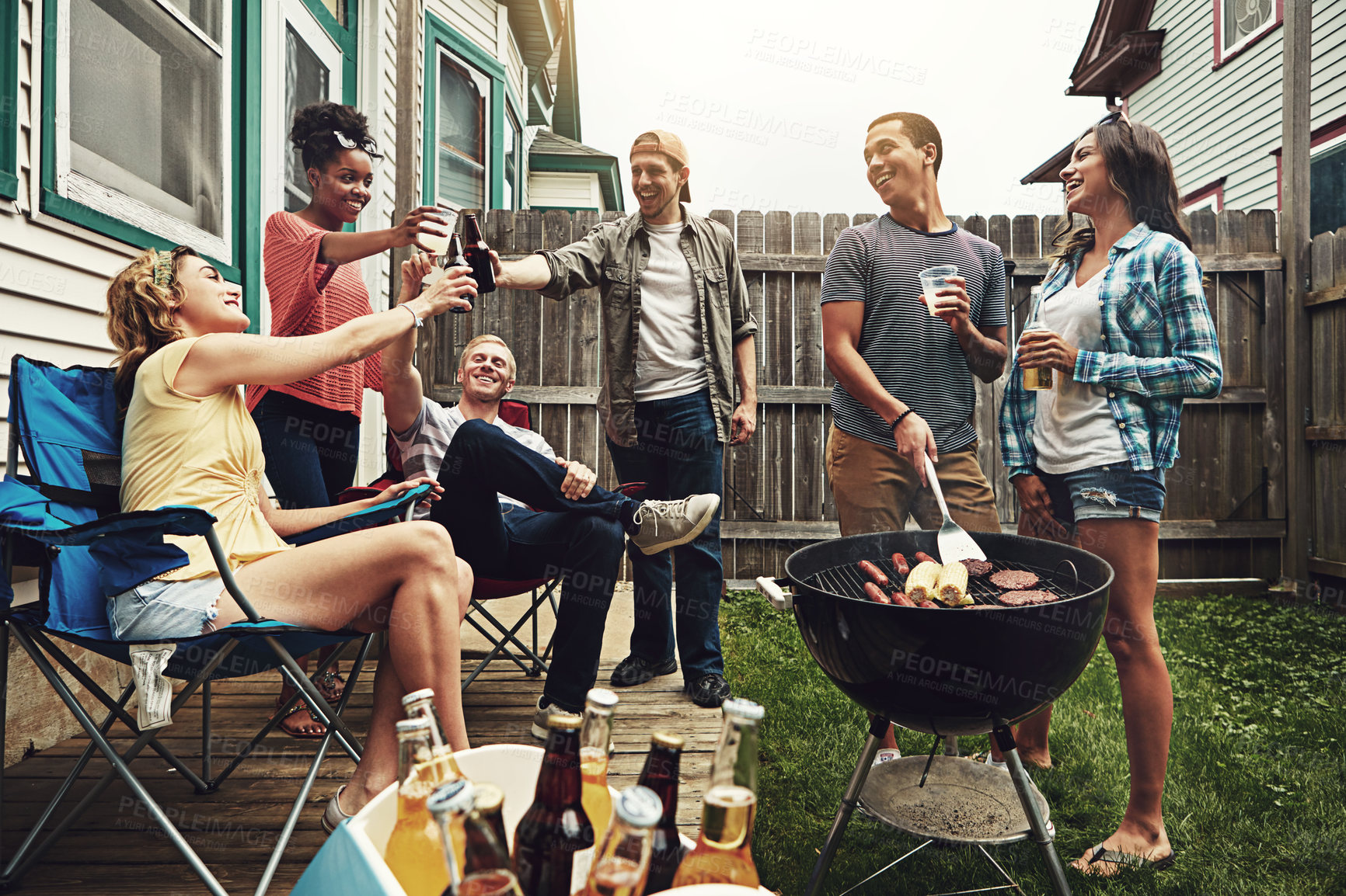 Buy stock photo Shot of a group of friends having a barbecue in the yard