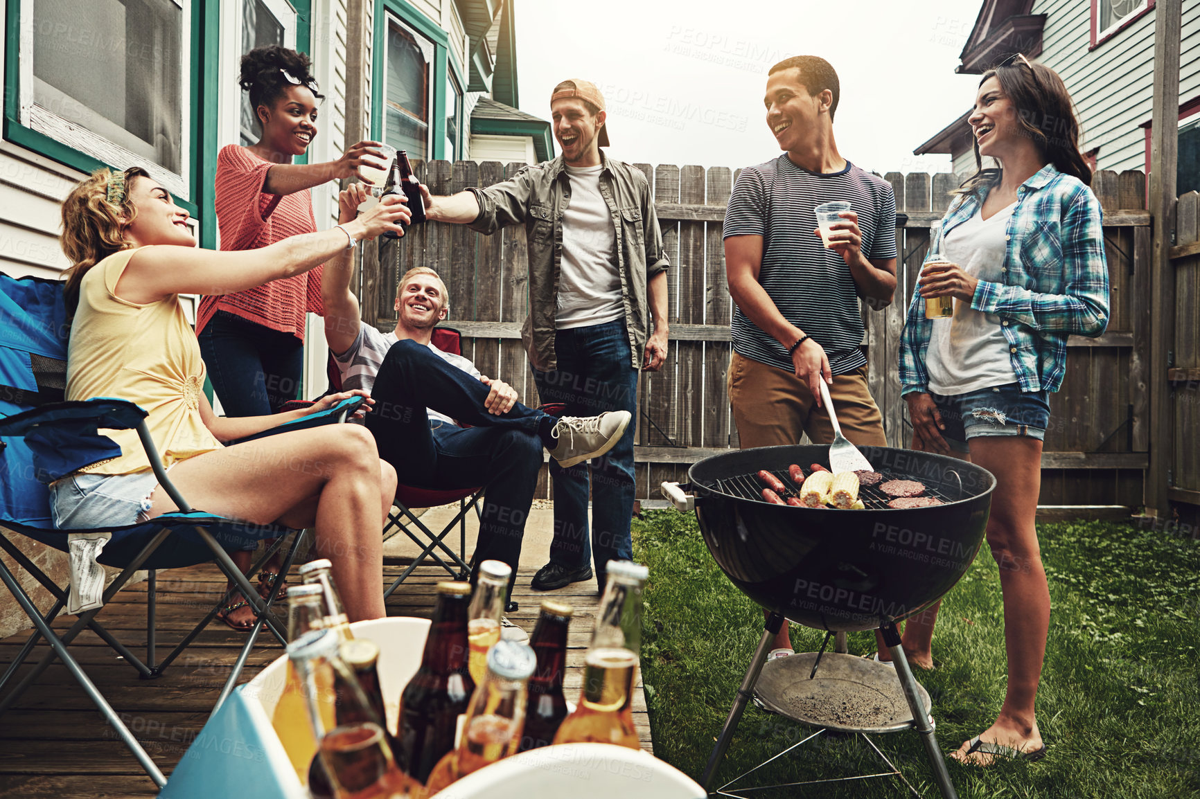 Buy stock photo Shot of a group of friends having a barbecue in the yard