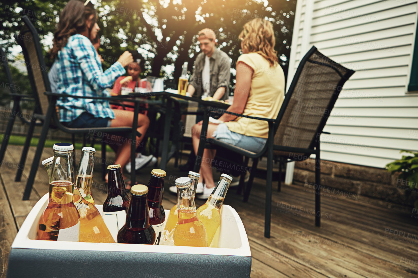 Buy stock photo Friends, people and drinks at barbecue in backyard, summer and vacation for holiday, celebration or event. Group, cheerful and bbq with cooler box for dinner, party or reunion with alcohol in America