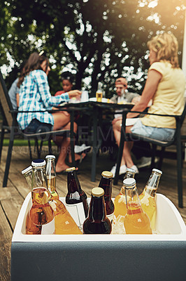 Buy stock photo Case, alcohol and outside on weekend with friends for beer, cider and spirits on porch or backyard. Reunion, social and dinner party with day camping, meal and summer in America with drinks for fun.