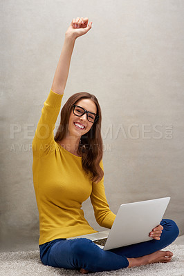 Buy stock photo Studio portrait of an attractive young woman posing with her laptop against a grey background