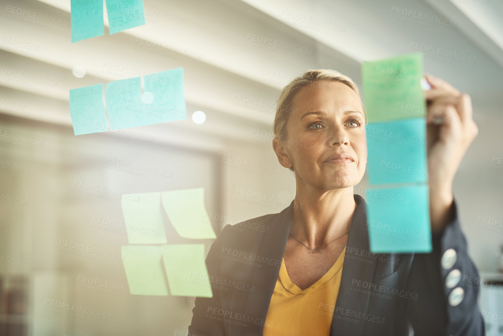 Buy stock photo Woman, employee and sticky notes on glass board at office for strategy, planning and vision. Brainstorming, ideas and writing for project at workplace with mission for solution and problem solving