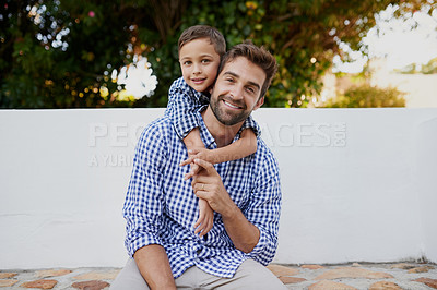 Buy stock photo Cropped portrait of a handsome young man and his son sitting outside