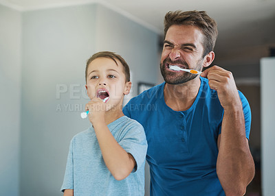 Buy stock photo Happy, brushing teeth and father with son in bathroom for morning routine, bonding and dental. Oral hygiene, cleaning and smile with man and child in mirror of family home for self care and wellness