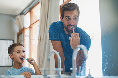 Buy stock photo Happy, brushing teeth and father with son in mirror of bathroom for morning routine, bonding and dental. Oral hygiene, cleaning and smile with man and child in family home for self care and wellness