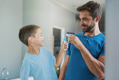 Buy stock photo Toothbrush, brushing teeth and father with son bathroom for morning routine, bonding and dental. Oral hygiene, cleaning and smile with man and child in family home for self care and wellness