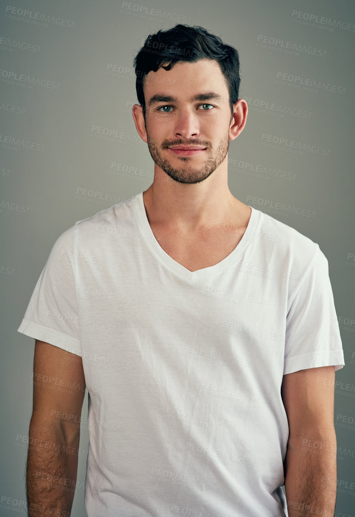 Buy stock photo Studio shot of a casual young man posing against a grey background