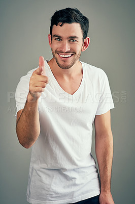 Buy stock photo Studio shot of a casual young man posing against a grey background