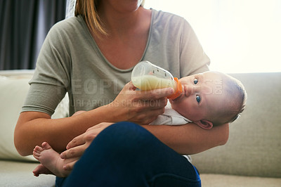 Buy stock photo Shot of an unrecognizable mother and her baby at home