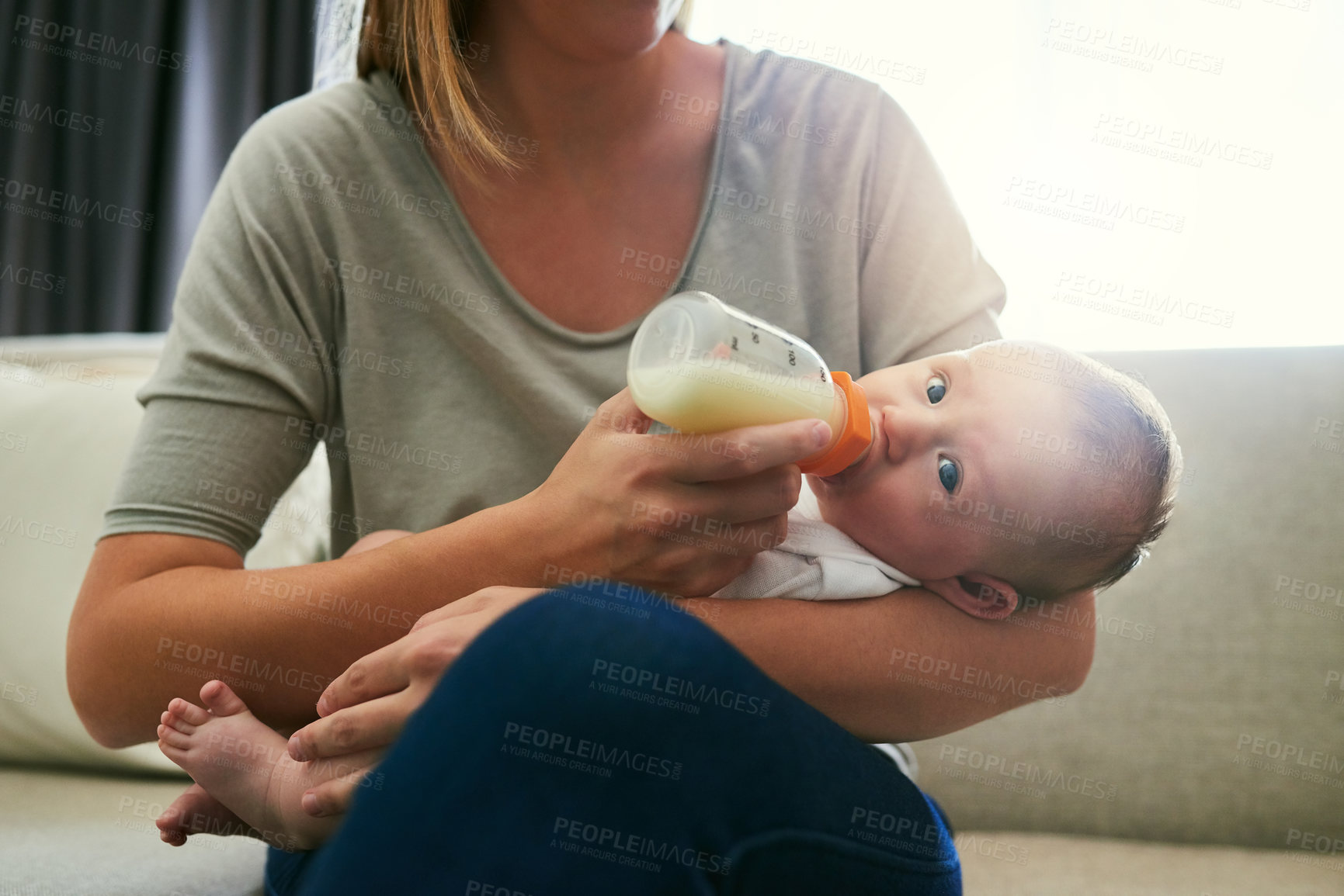 Buy stock photo Shot of an unrecognizable mother and her baby at home