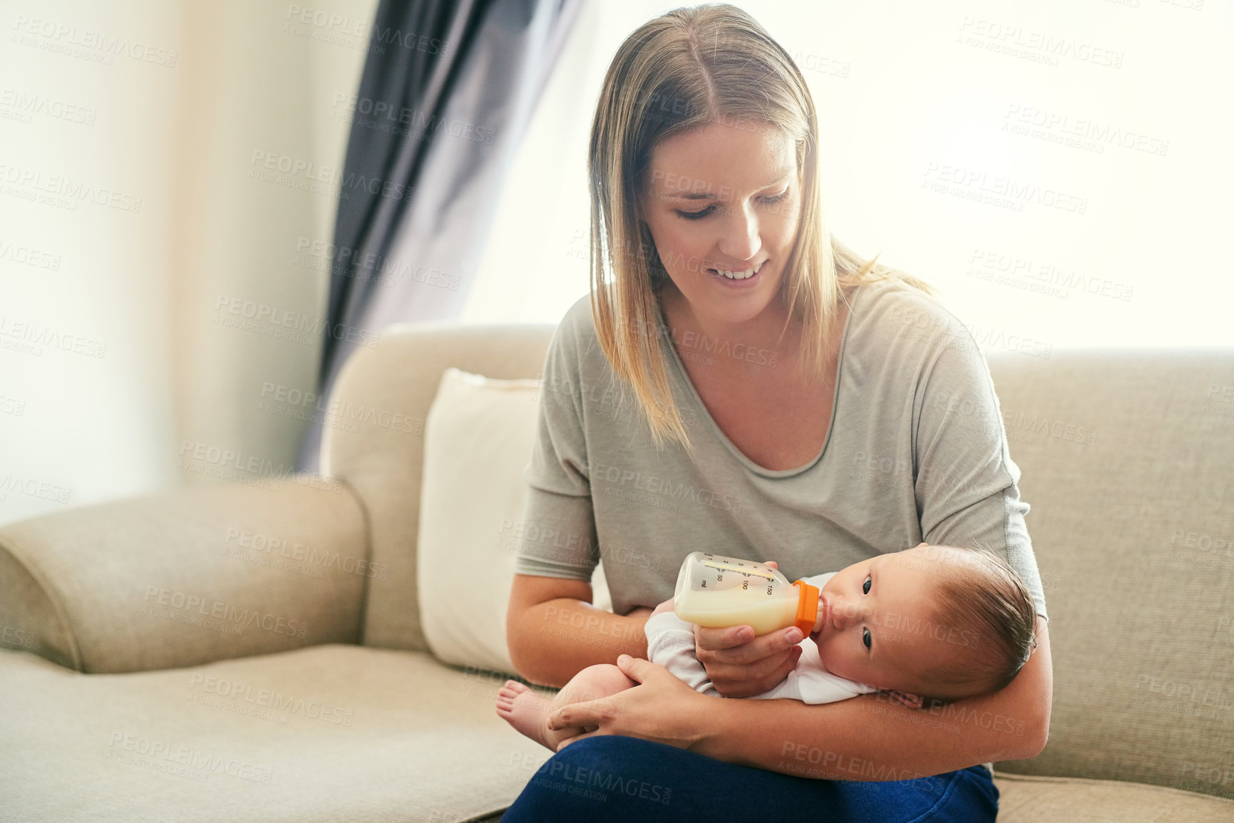 Buy stock photo Mom, milk and feeding baby on sofa for growth development, nutrition or digestive health. Formula, woman parent and infant child with bottle for drinking, wellness or bonding with love in home