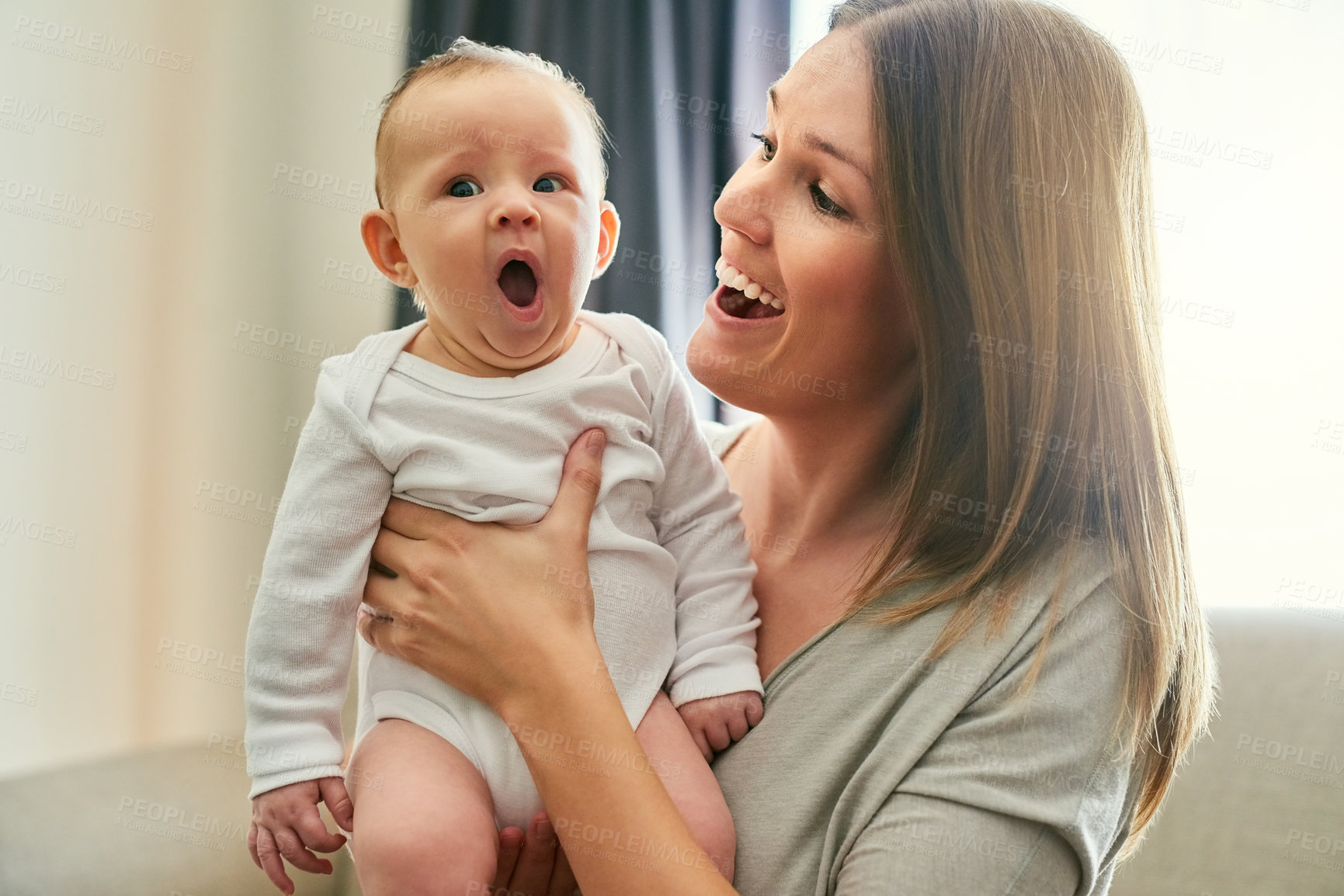 Buy stock photo Shot of a young mother and her baby at home