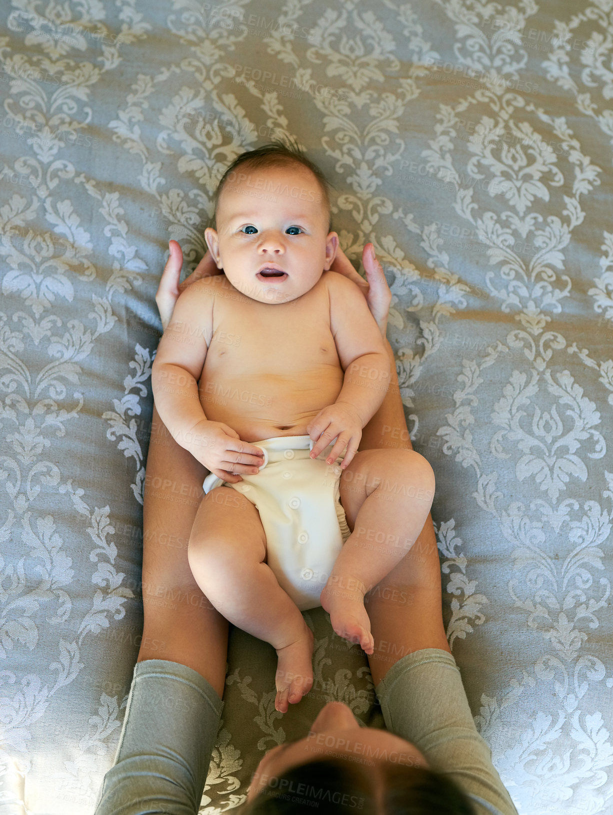 Buy stock photo Hands, top view and mom with portrait of baby in bedroom for growth, development and family care and love. Mother, toddler and home with support, adorable and bonding for emotional connection.