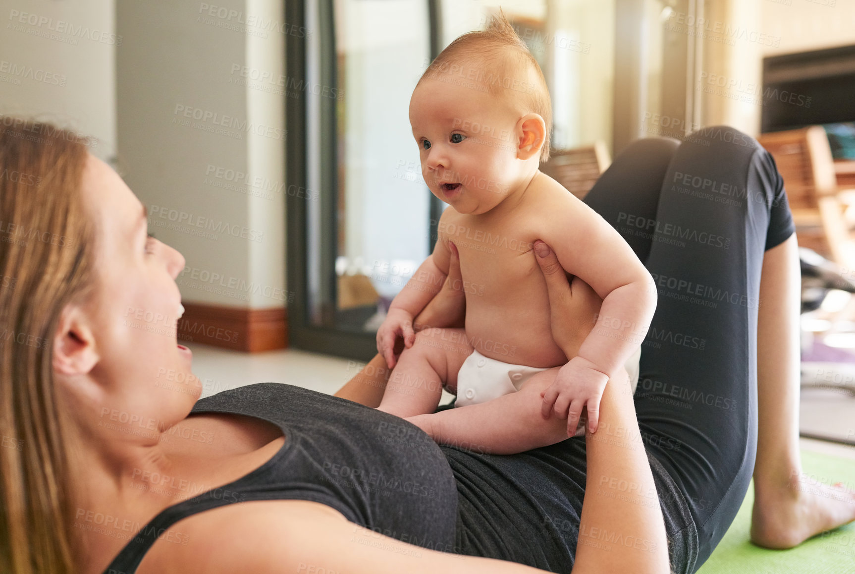 Buy stock photo Shot of a young mother and her baby at home