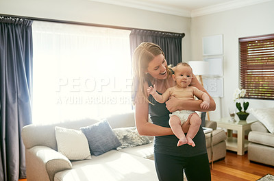 Buy stock photo Home, baby and mom with smile in living room, love and bonding of woman with child, family and sofa. House, parent and carrying of newborn in lounge, together and happy for motherhood and affection