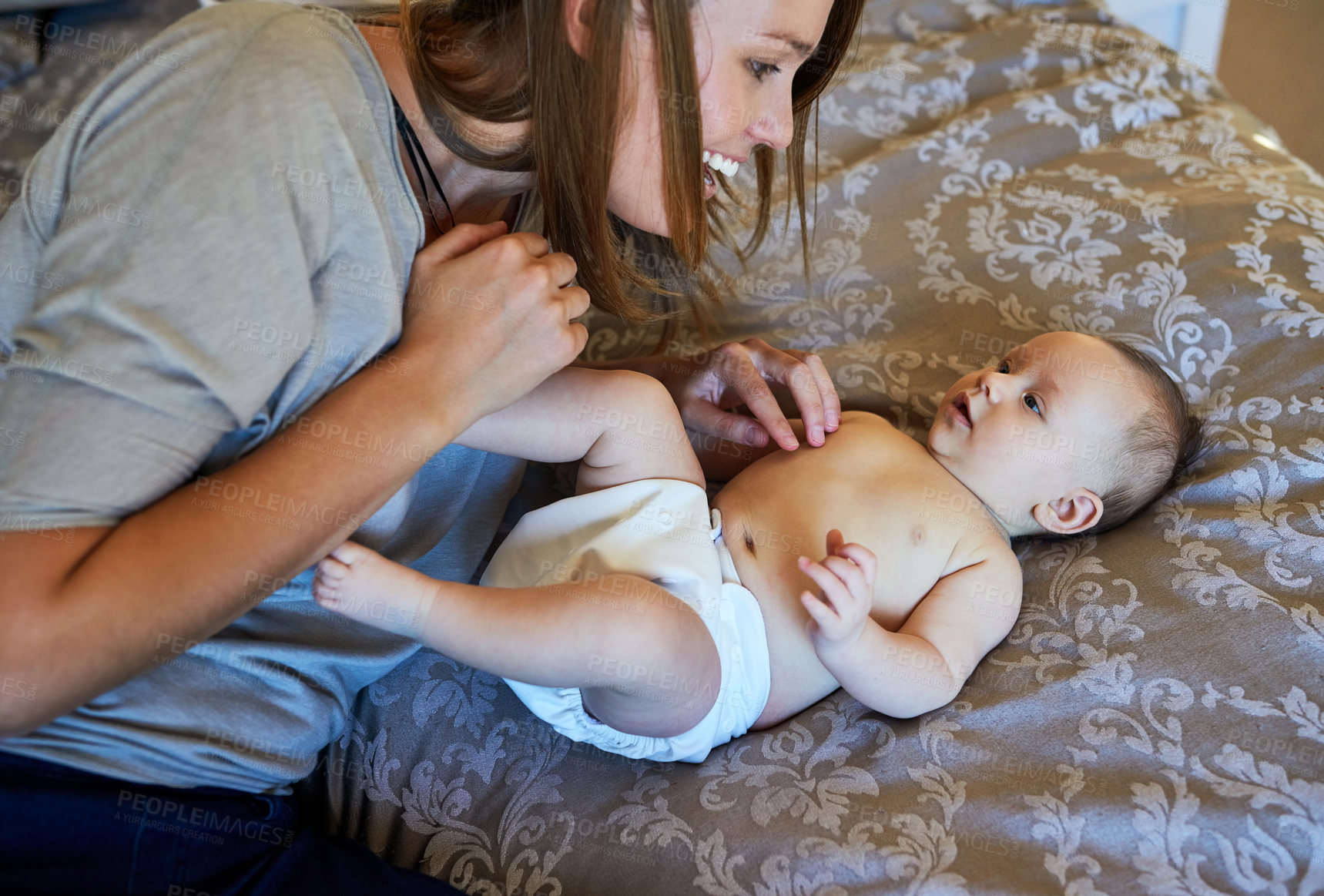 Buy stock photo Bed, baby and mom with smile in home, love and bonding of woman with child, family and tickling. House, parent and playing with infant in bedroom, together and happy for motherhood and affection