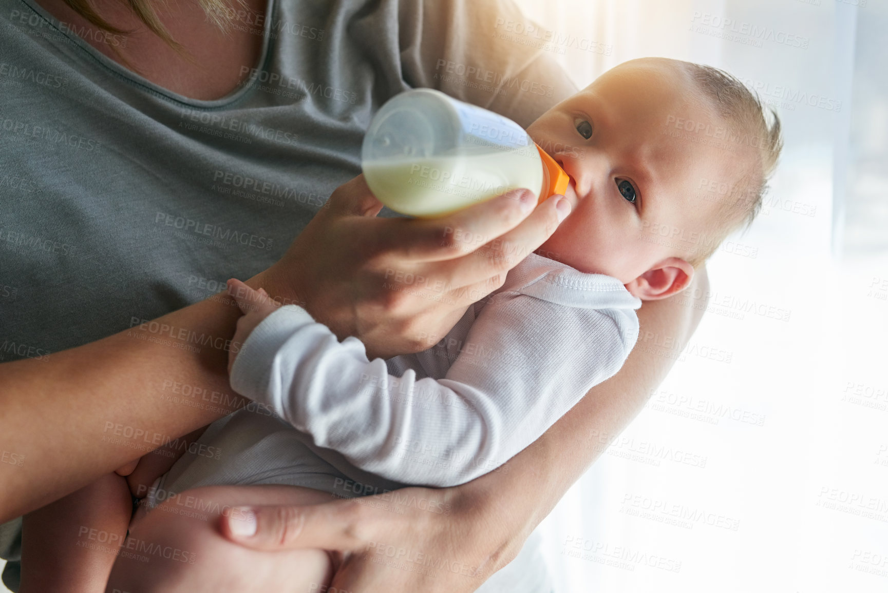 Buy stock photo Shot of an unrecognizable mother and her baby at home