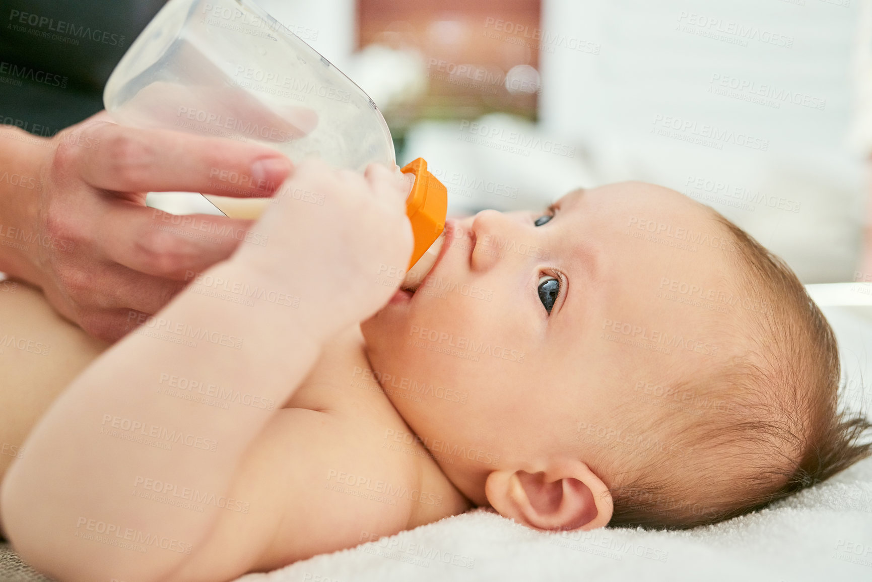 Buy stock photo Baby, hands and milk bottle in nursery with formula for nutrition, feeding routine and breakfast in morning. Person, child and drinking for family support, food health and growth development at house