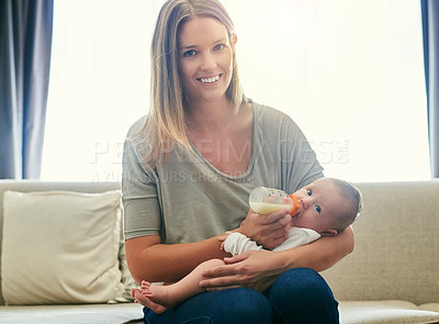 Buy stock photo Shot of a young mother and her baby at home