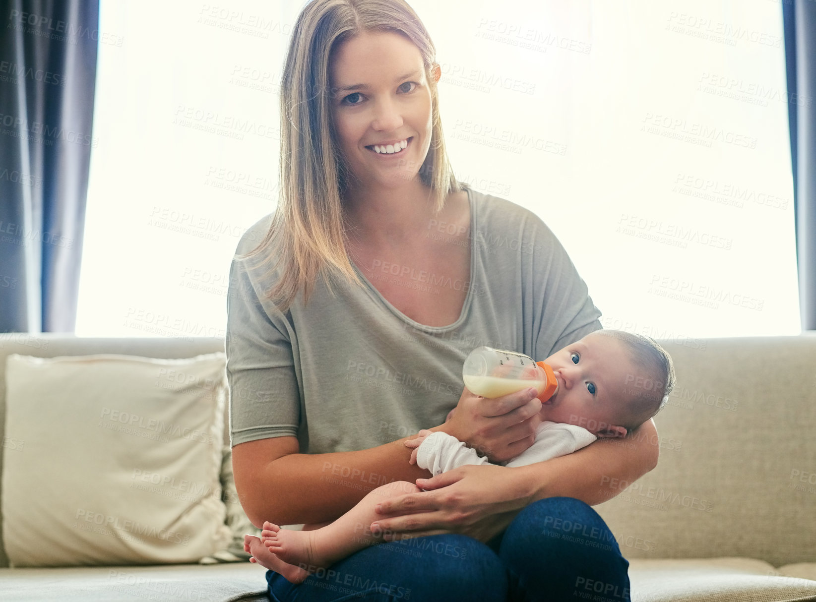 Buy stock photo Shot of a young mother and her baby at home