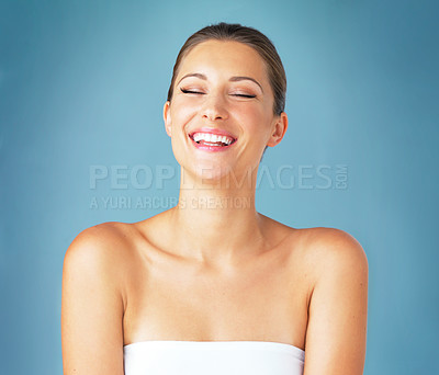 Buy stock photo Studio shot of a beautiful young woman posing against a blue background