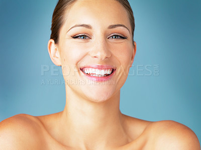Buy stock photo Smile, cosmetics and portrait of happy woman with dermatology, skincare and makeup on blue background. Happiness, skin care and wellness, face of model with beauty and facial glow on studio backdrop.