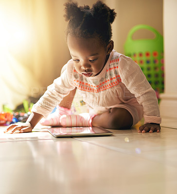 Buy stock photo Black child, little girl and playing with tablet on floor for online learning, streaming or education in living room at home. Young African, baby or toddler with technology for childhood development