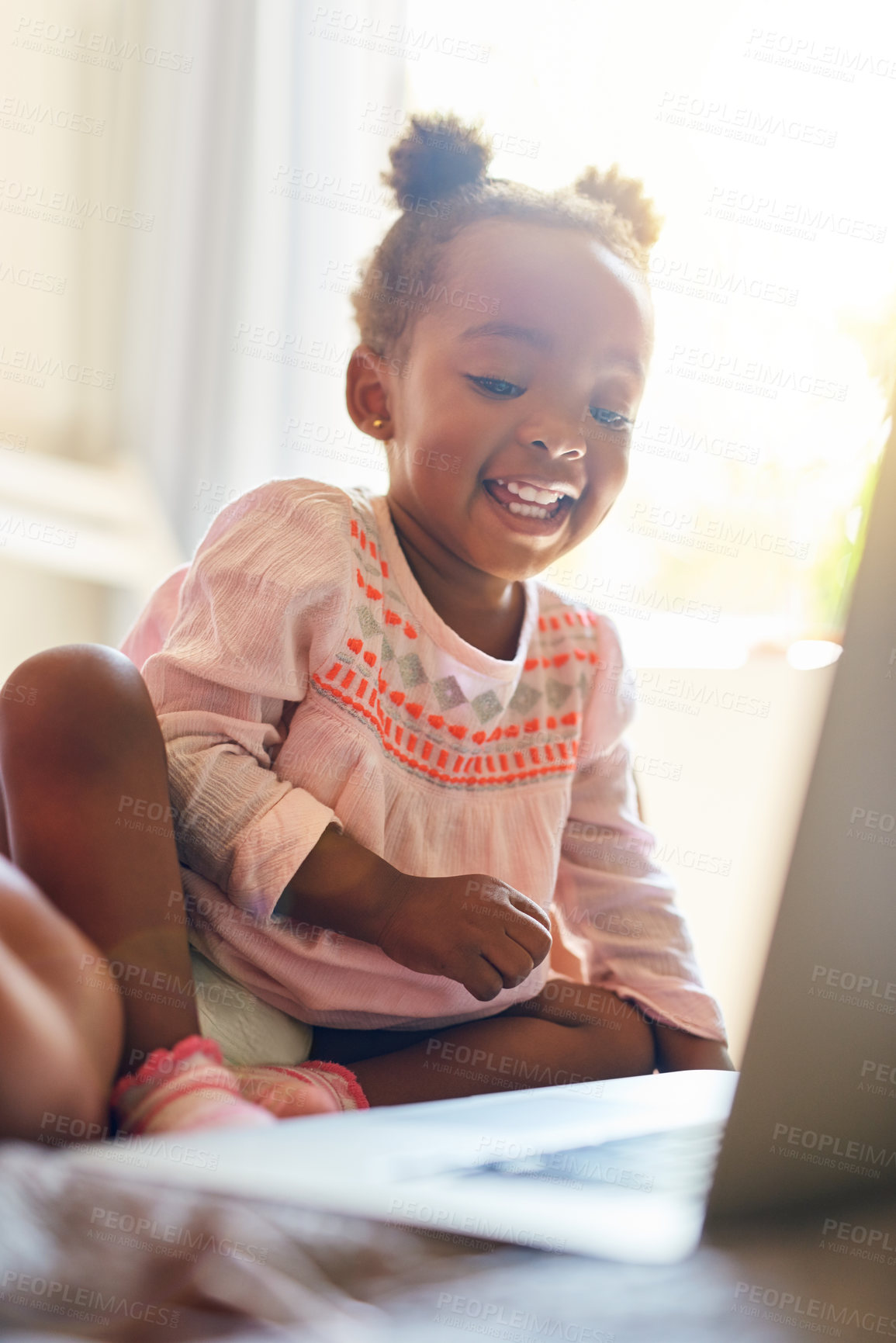 Buy stock photo Girl child, happy and relax with laptop in home for creative activities, learning and streaming movies. Toddler, online and technology for curiosity or engaging for education growth or development.