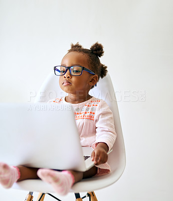 Buy stock photo Cropped shot of an adorable little girl playing on a laptop at home