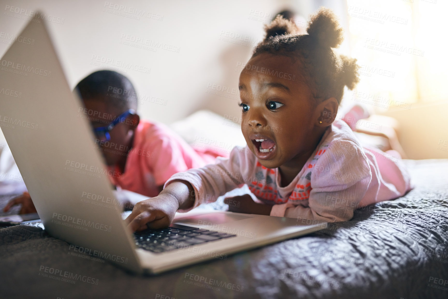 Buy stock photo Girl child, online and bedroom with laptop in home for creative activity, learning and streaming movies. Toddler, internet and technology for curiosity or engaging for education growth or development