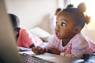 Buy stock photo Girl child, online and relax with laptop in home for creative activities, learning and streaming movies. Toddler, internet and technology for curiosity or engaging for education growth or development